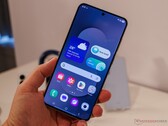 Bilden visar en Galaxy S25 FE som hålls av en recensent 