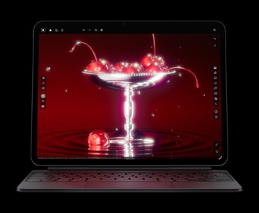 Apple iPad Pro M5 med Magic Keyboard visar en 3D-rendering av körsbär, vilket visar Ultra Retina XDR OLED-skärmen och M5-chipgrafiken (Bildkälla: Apple)