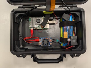Raspberry Pi, batteri och andra komponenter inuti höljet.