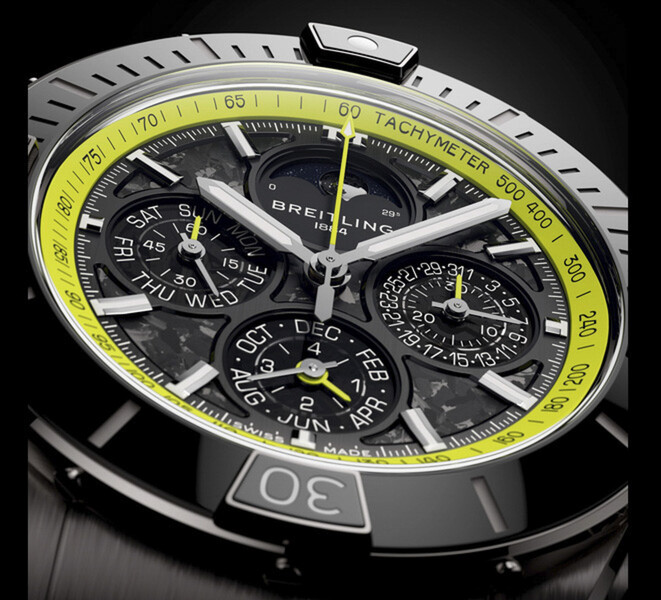 Närbild av Breitling Super Chronomat B19 44 Perpetual Calendar Chronograph som visar dess urtavla i kolfiber, kalenderns delurtavlor, silverfärgade visare och limegröna takymeterskala.