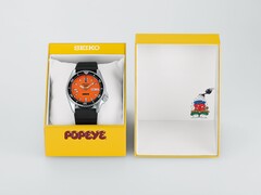 Seiko 5 Sports x Popeye HDB013, en automatisk klocka med orange urtavla, som ligger bredvid sin gula presentask i begränsad upplaga.