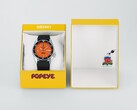 Seiko 5 Sports x Popeye HDB013, en automatisk klocka med orange urtavla, som ligger bredvid sin gula presentask i begränsad upplaga.