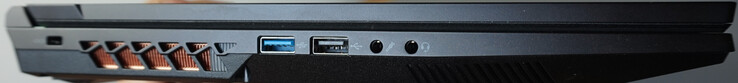 Vänster: Kensingtonlås, USB-A (5 Gbit/s), USB-A (0,5 Gbit/s), mikrofon, headset